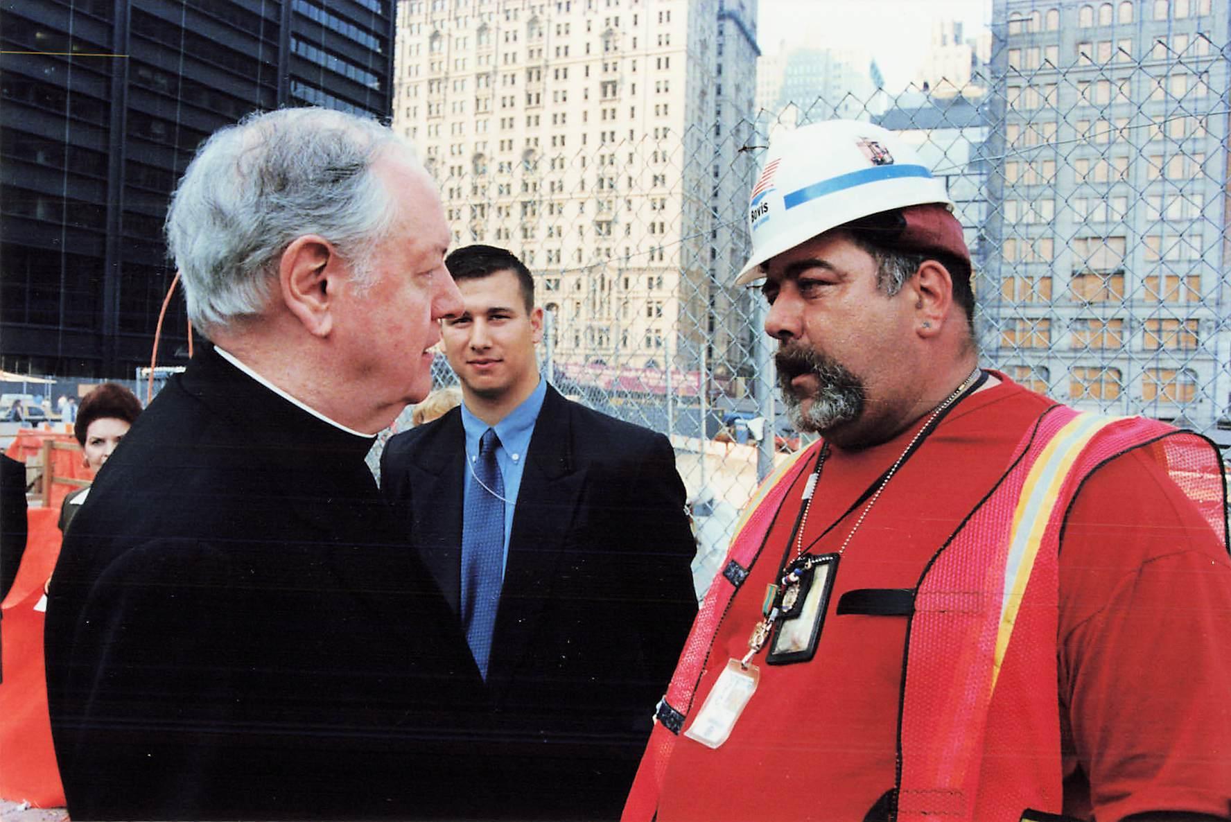 Cardinal Egan speaks with a recovery worker at Ground Zero